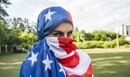 A Muslim woman wearing a headscarf made of the United States' flag.